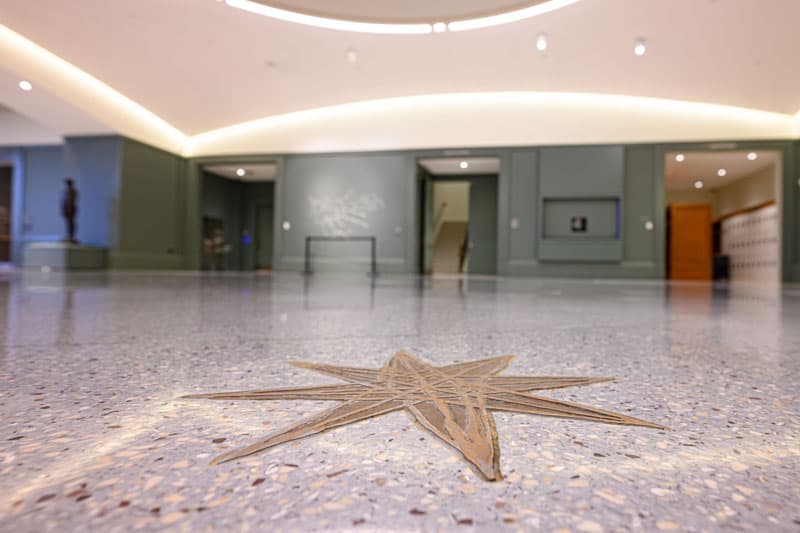 A close up of one of the hand-drawn stars that were cast into bronze on the floor of the museum. 