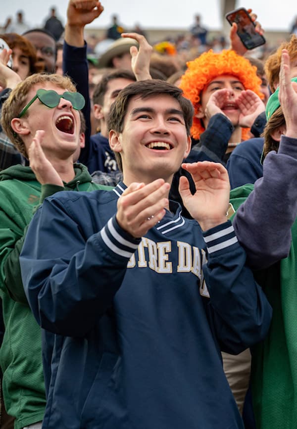 A diverse crowd of students clapping and cheering