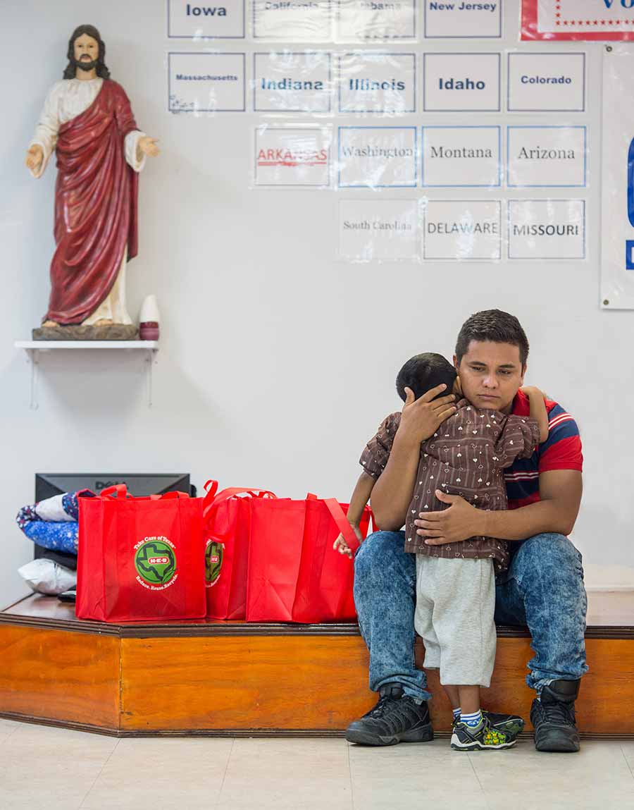 Jose sitting down and hugging his son.