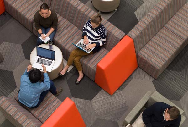 Notre Dame graduate students discuss projects between classes in McCourtney Hall common space.