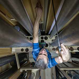 September 9, 2016; Pipe maker Erik McLeod tunes wooden pipes of the Pedal Violon 16’. (Photo by Barbara Johnston/University of Notre Dame)