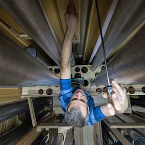 September 9, 2016; Pipe maker Erik McLeod tunes wooden pipes of the Pedal Violon 16’. (Photo by Barbara Johnston/University of Notre Dame)
