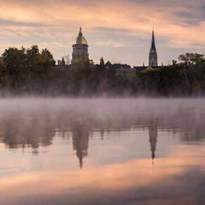October 18, 2016; St. Joseph Lake at sunrise with the Main Building and Golden Dome in the background. (Photo by Barbara Johnston/University of Notre Dame)