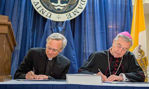  University of Notre Dame President Rev. John I. Jenkins, C.S.C. and Archbishop Jean-Louis Brugues, Archivist and Librarian of the Holy Roman Church, sign a memorandum of understanding for collaboration and exchanges between the Vatican Library and Notre Dame.