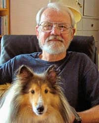 Gerald L. Bruns and his dog pose for a photo.
