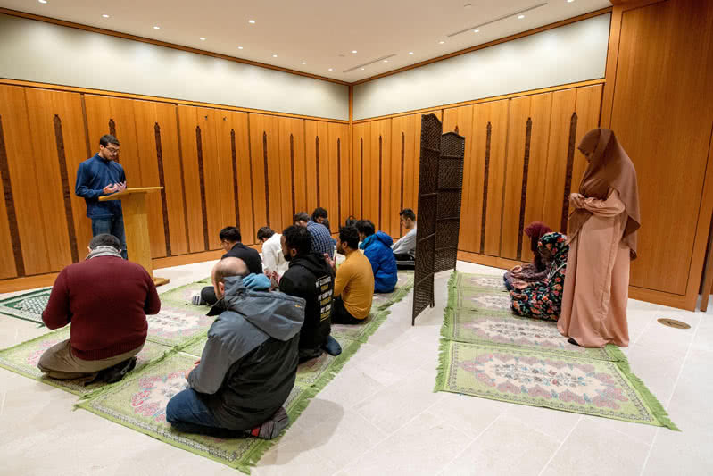 Members sitting on the floor during a worship ceremony.