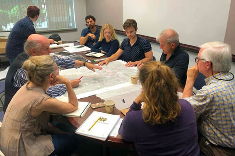 A group of people at an office table.