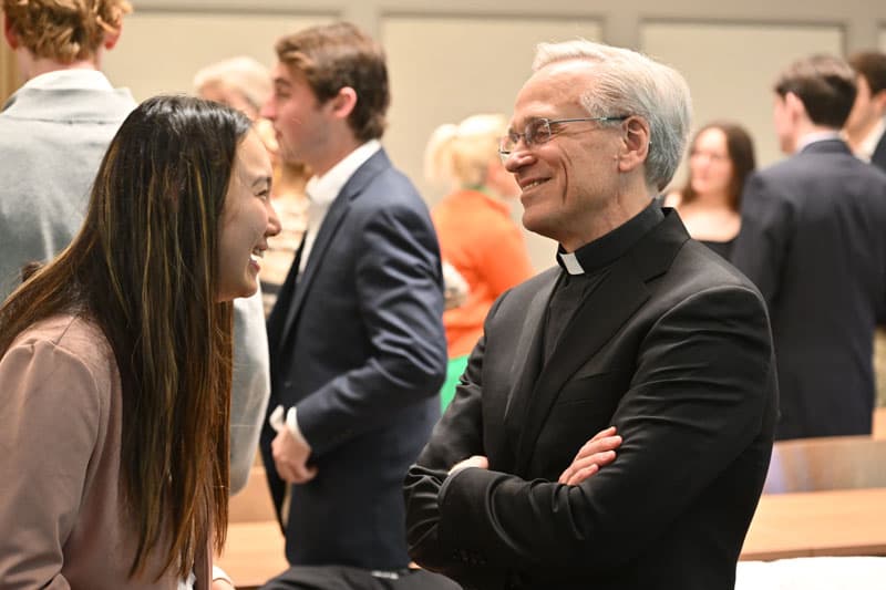 Fr. John Jenkins talks with a student.