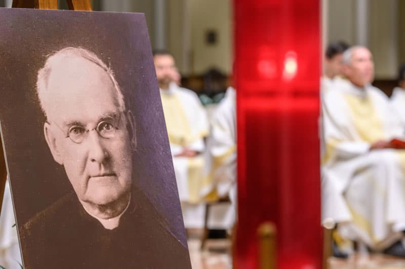 A poster of Brother Columba O’Neill at the altar at Mass.