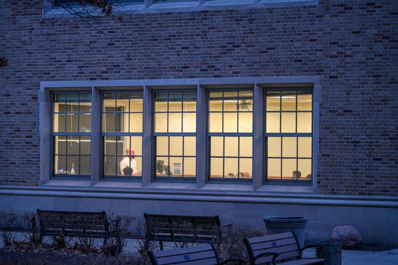 A view of a brightly lit classroom from the outside.