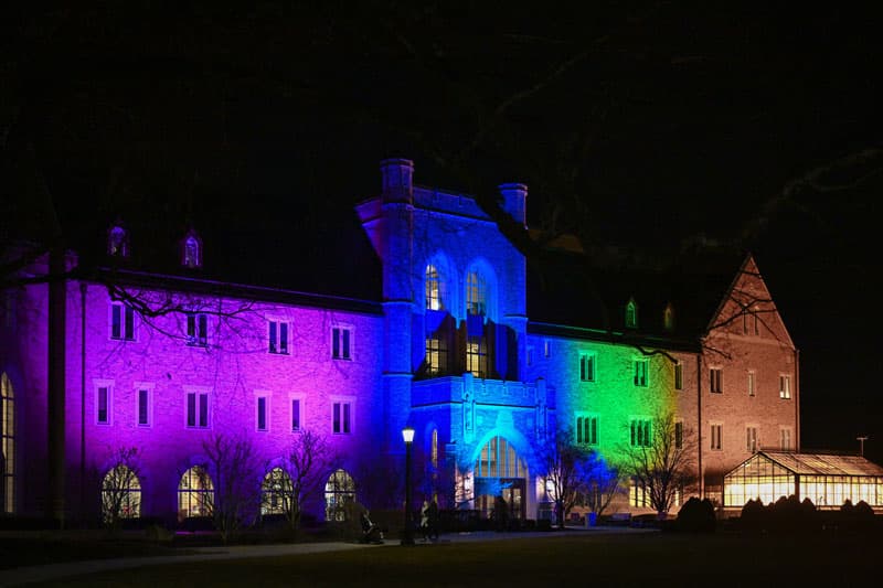 The Jordan Hall of Science lit up in purples, blues, and greens for Rare Disease Day.