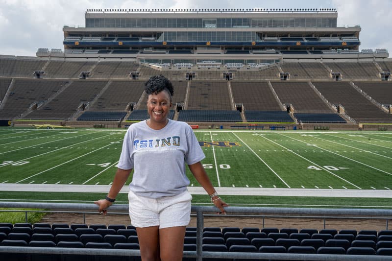 Jennifer Liddell stands in her TSUND t-shirt in Notre Dame stadium.