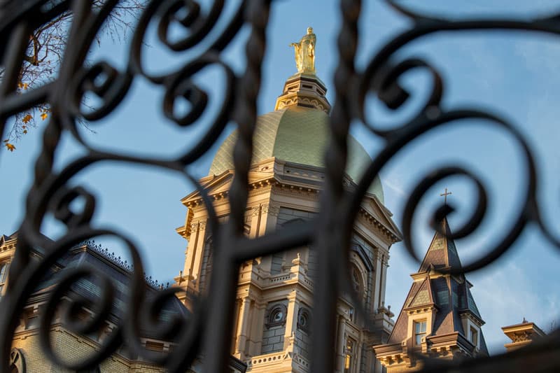 The Golden Dome as viewed from below through a scrollwork fence.
