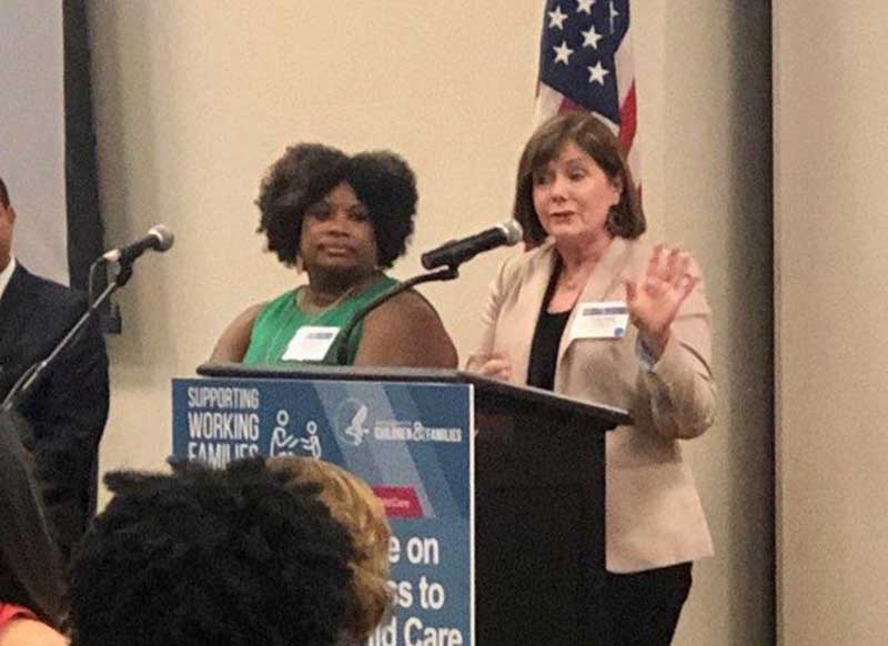 Cindy Casey at a podium speaking.