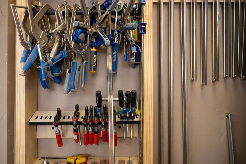 Woodworking clamps hanging on a wall.