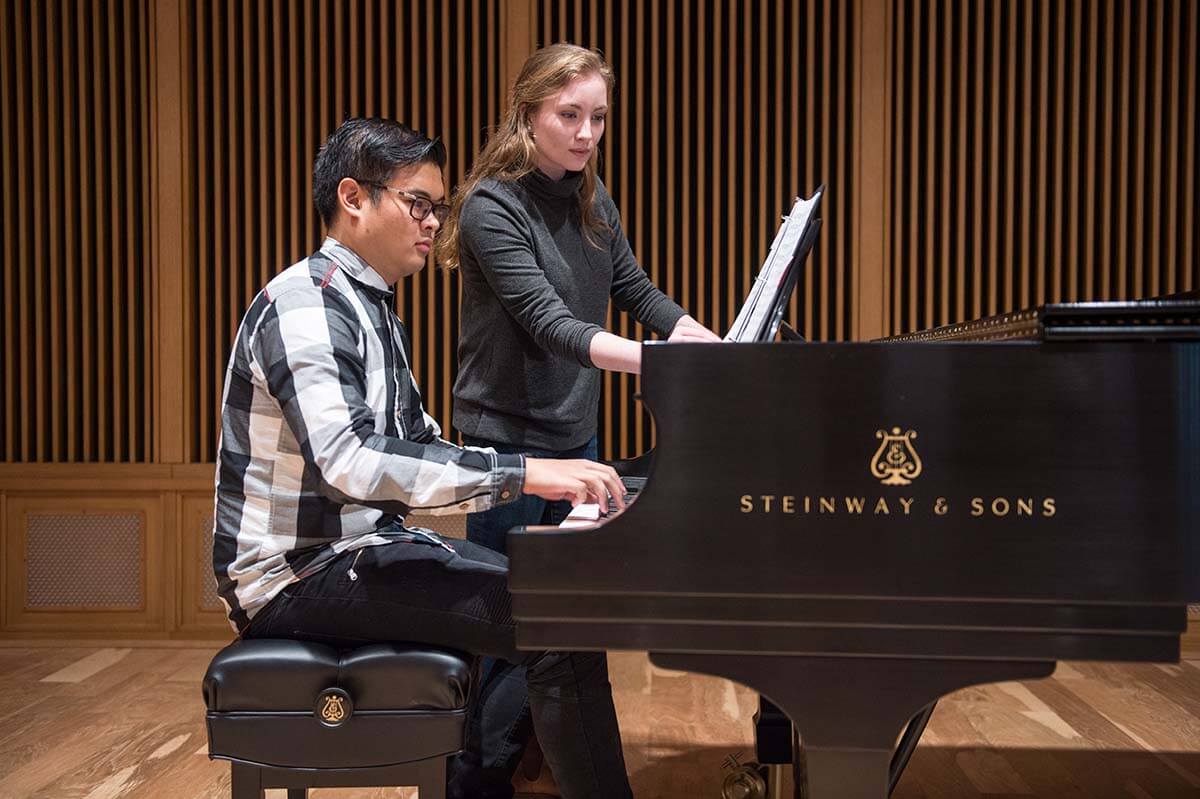 Joseph Tang practices piano while Aileen Markovitz sings.