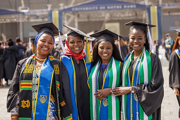 Four women standing in their graduation attire after the Notre Dame commencement ceremonies