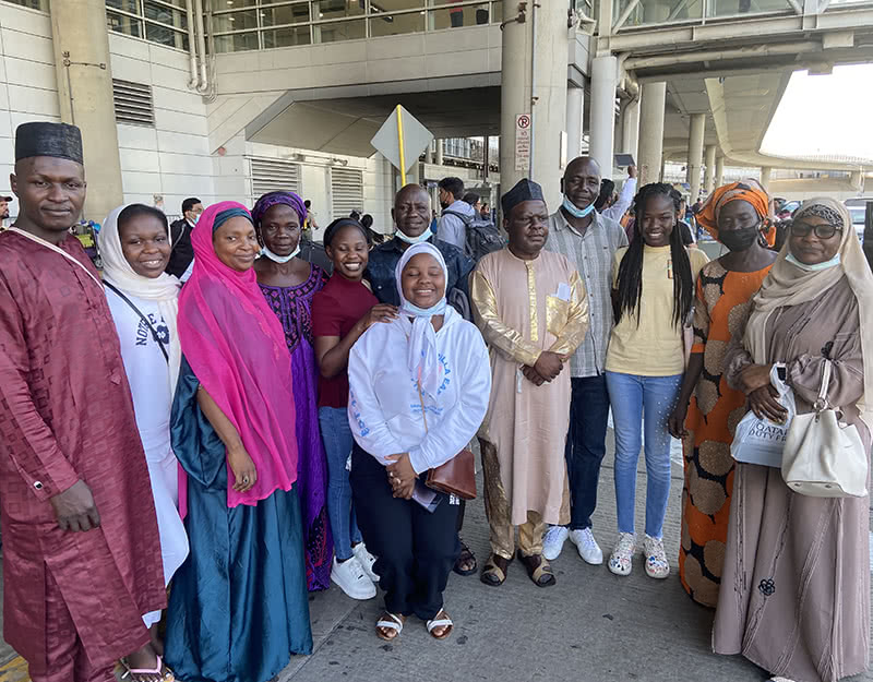 Nigerian family members posing with the girls.