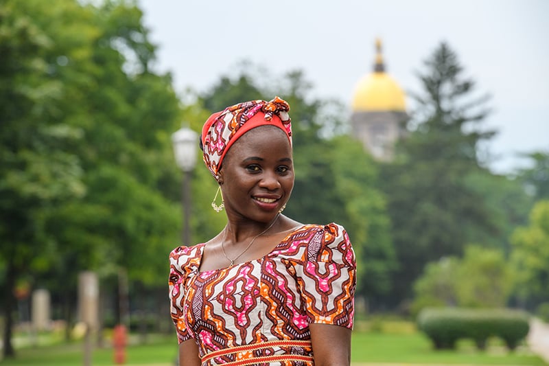 Godiya standing in front of the golden dome.