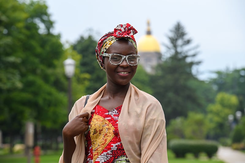 Maijidda standing in front of the golden dome.