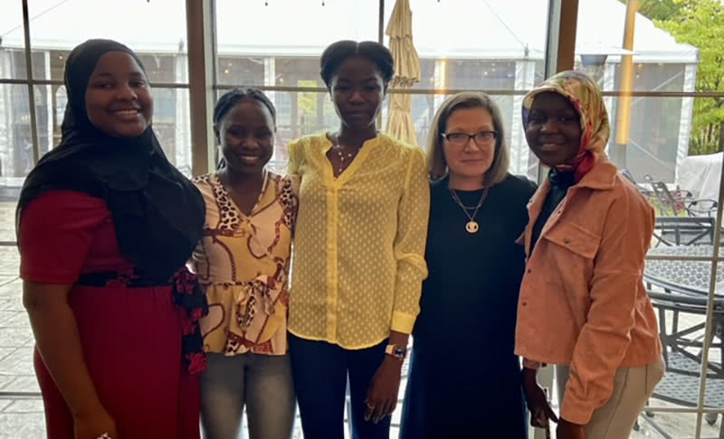 Dean of College of Arts and Letters, Mustillo, with all 4 Nigerian girls.