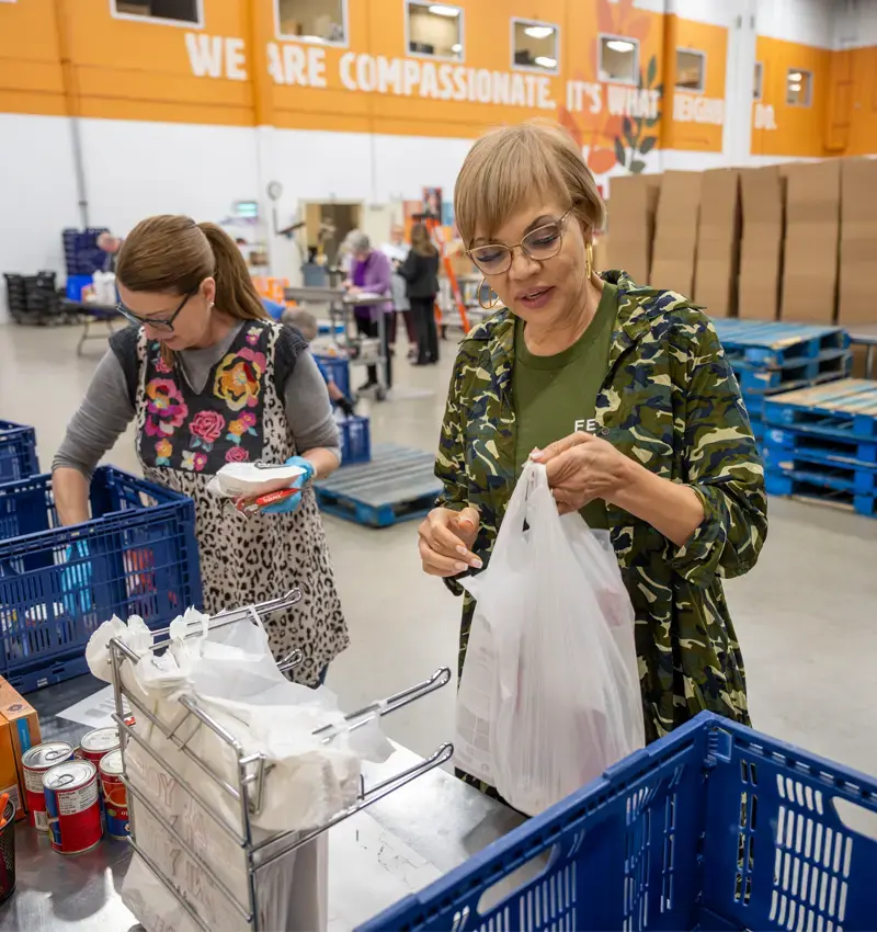 Babineaux-Fontenot works with volunteers to package food orders at the Northern Illinois Food Bank.
