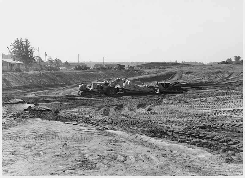 Workers clearing the land for the site of Memorial Library (later Hesburgh Library), 1961.