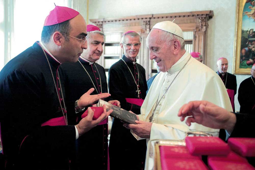 Hanna giving Pope Francis his book