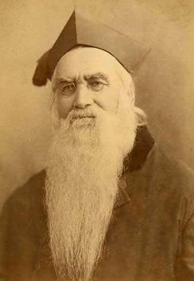 A bearded priest wearing a robe.
