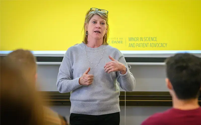 A portrait of Barb Calhoun standing at the front of a classroom.