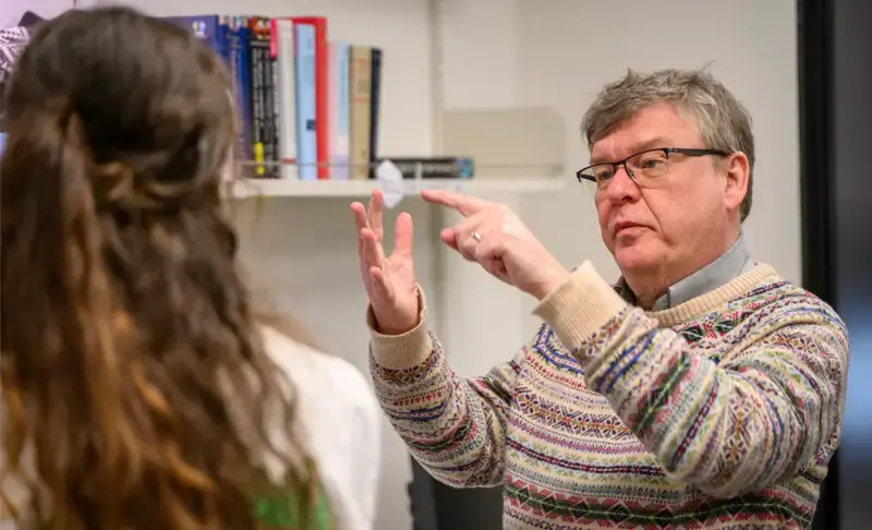  Olaf Wiest talks with a researcher in his McCourtney Hall lab.