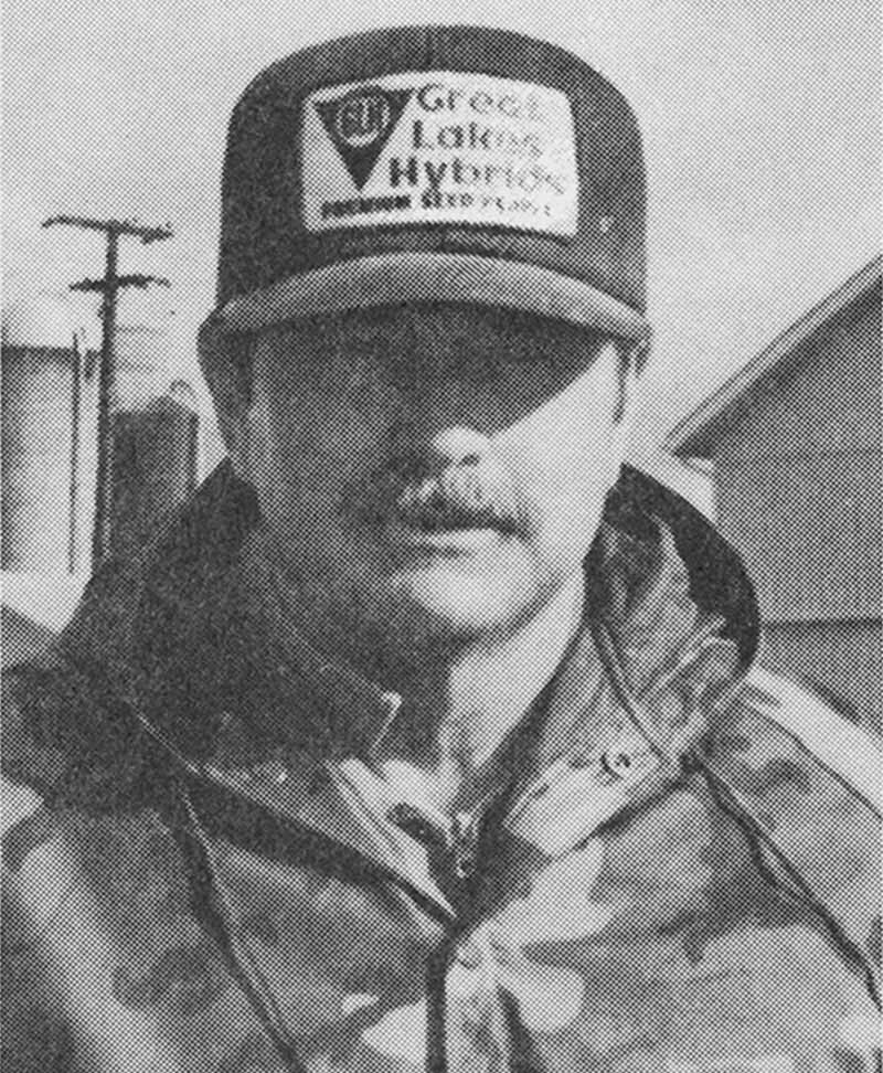 An archival headshot photo of Don Dunleavy wearing a hat outside on the farm.