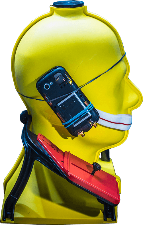 A yellow mannequin head with a modified mobile phone strapped to the side.