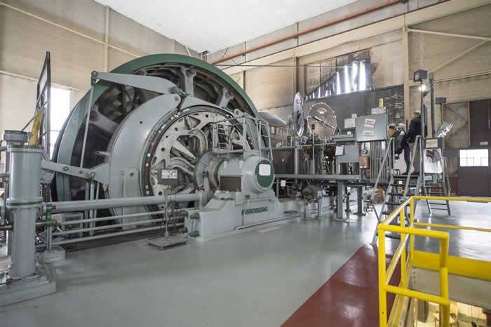 A hoist drum spooling more than 5,000 feet of steel rope lifts and lowers the elevator in the mine shaft.