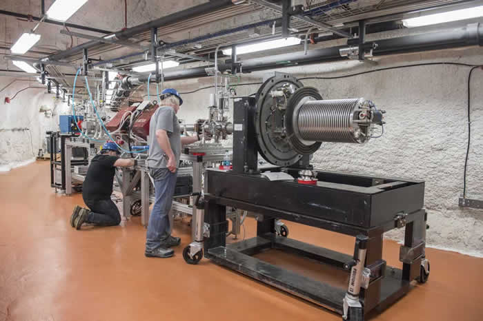 Daniel Robertson, Research Assistant Professor from Notre Dame and Frank Strieder, Associate Professor of Physics from the South Dakota School of Mines and Technology, (right) assemble the Compact Accelerator System.