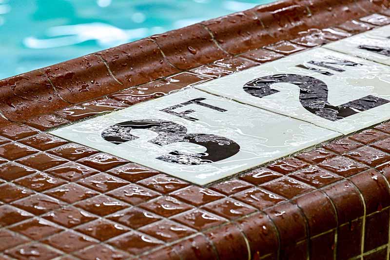 A detail shot of a wet pool floor. Three feet, two inches is displayed on the ground.