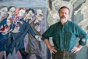 Maxim Kantor standing in front of one of his paintings.