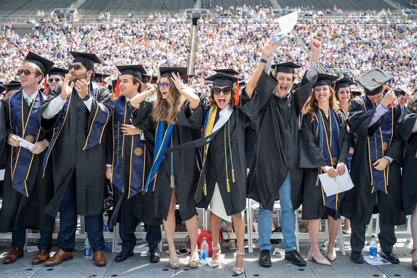 Graduates of the class of 2020 celebrate at the close of the 2020 Commencement ceremony in Notre Dame Stadium.