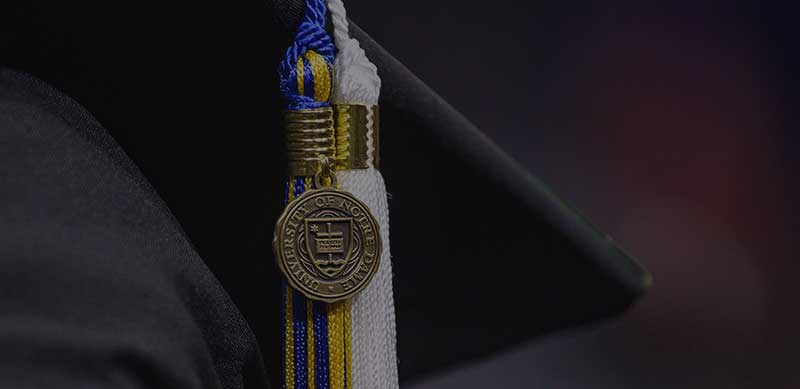 A close up of a graduates gap and tassel.