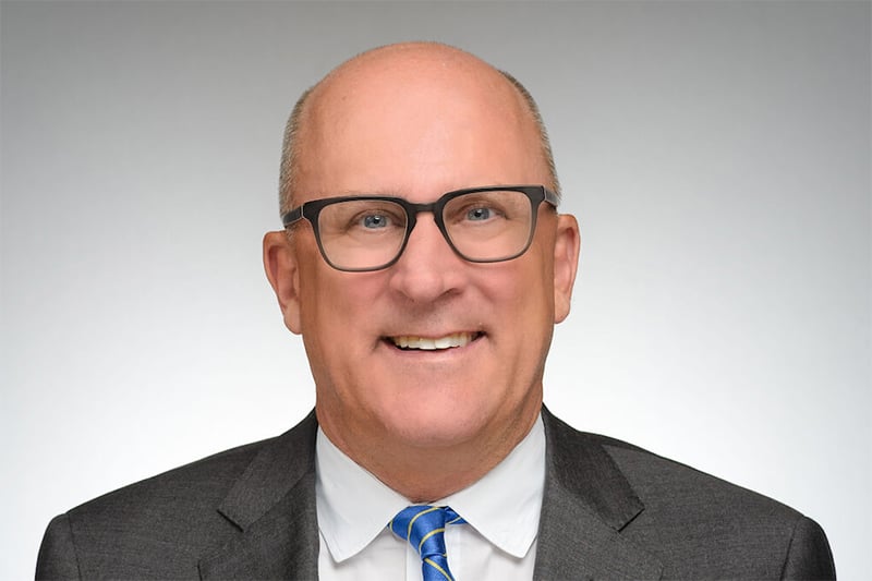 Portrait of Provost John McGreevy on light gray background