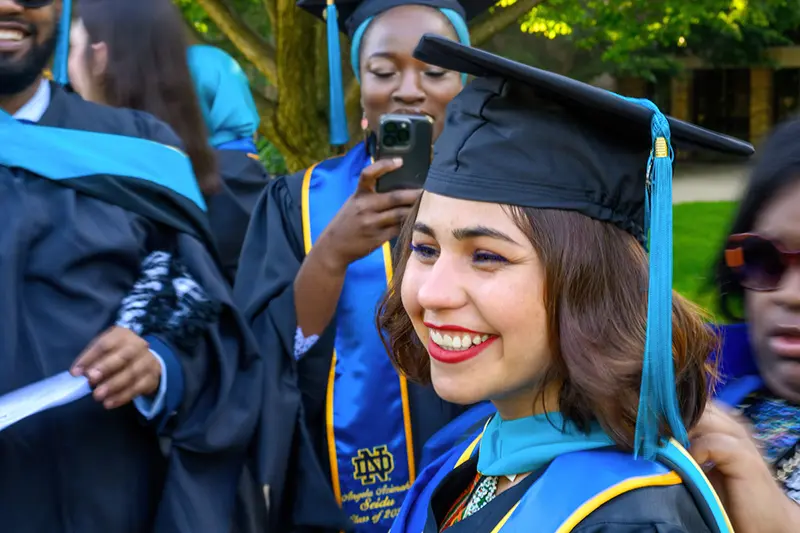 A graduate smiles after commencement ceremony.