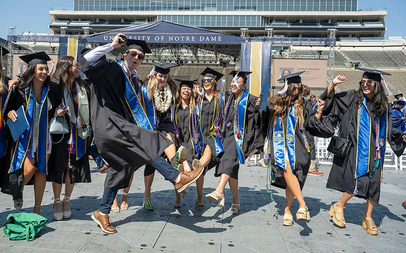 A graduate holds their diploma after the completion of the commencement ceremony.