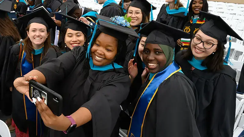 A group of Master's students staking a selfie.