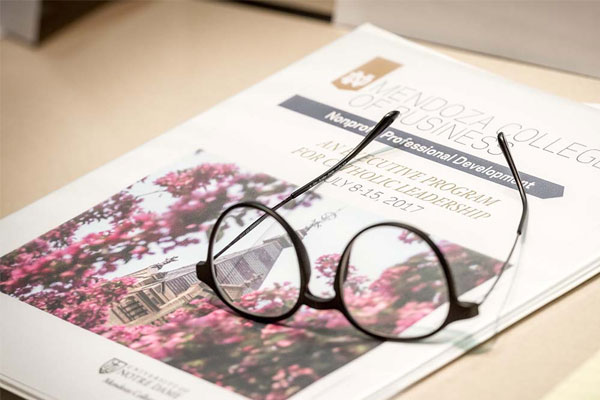 A photo of glasses on top of an open magazine.