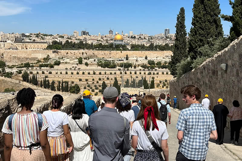 Group of students walk towards the Holy Land of Jerusalem