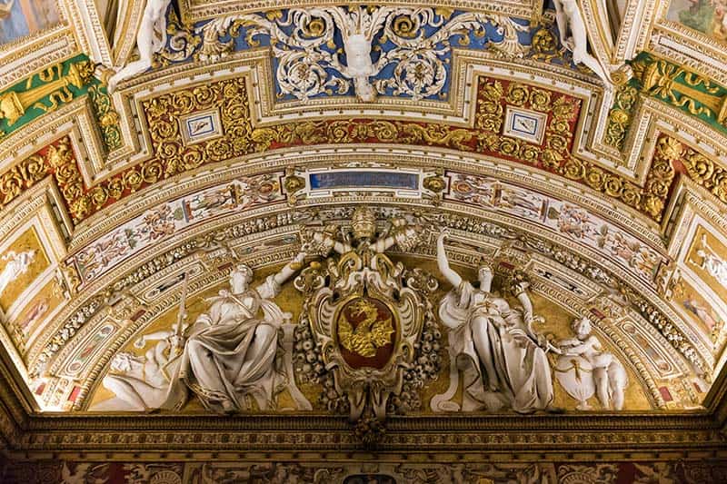 Ornate mouldings over an archway in the Vatican Museum.