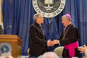 Fr. Jenkins shakes hands with Archbishop Jean-Louis Brugues.