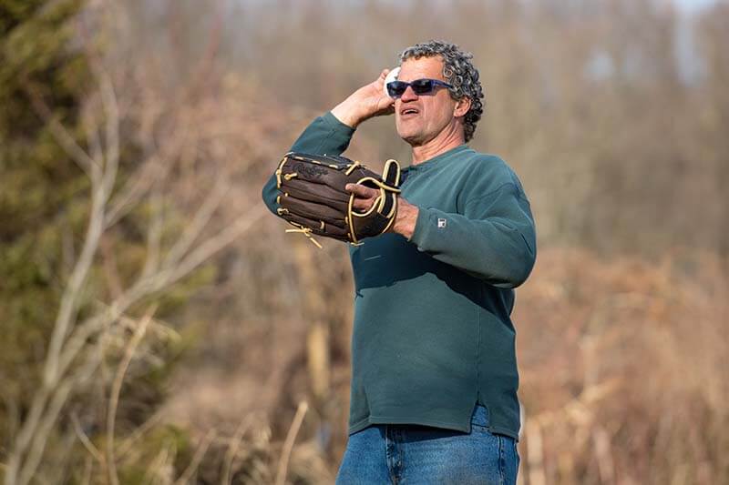 Doug Anderson throwing a softball.