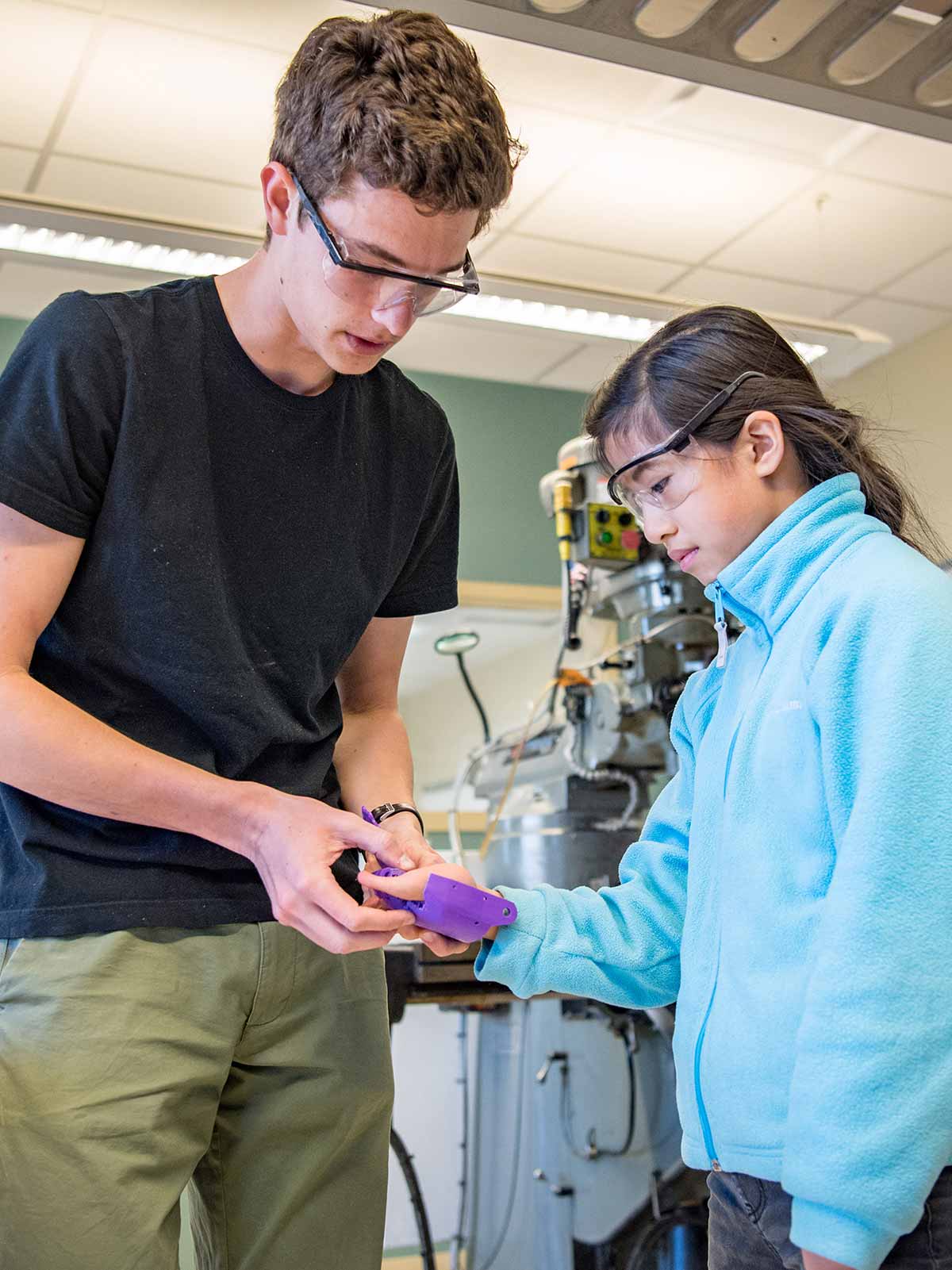 Cole Grabowski fits Tori Anderson with a 3D-printed prosthetic hand.