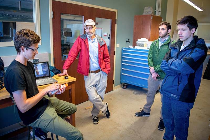 Richard Strebinger talking with students in the lab.